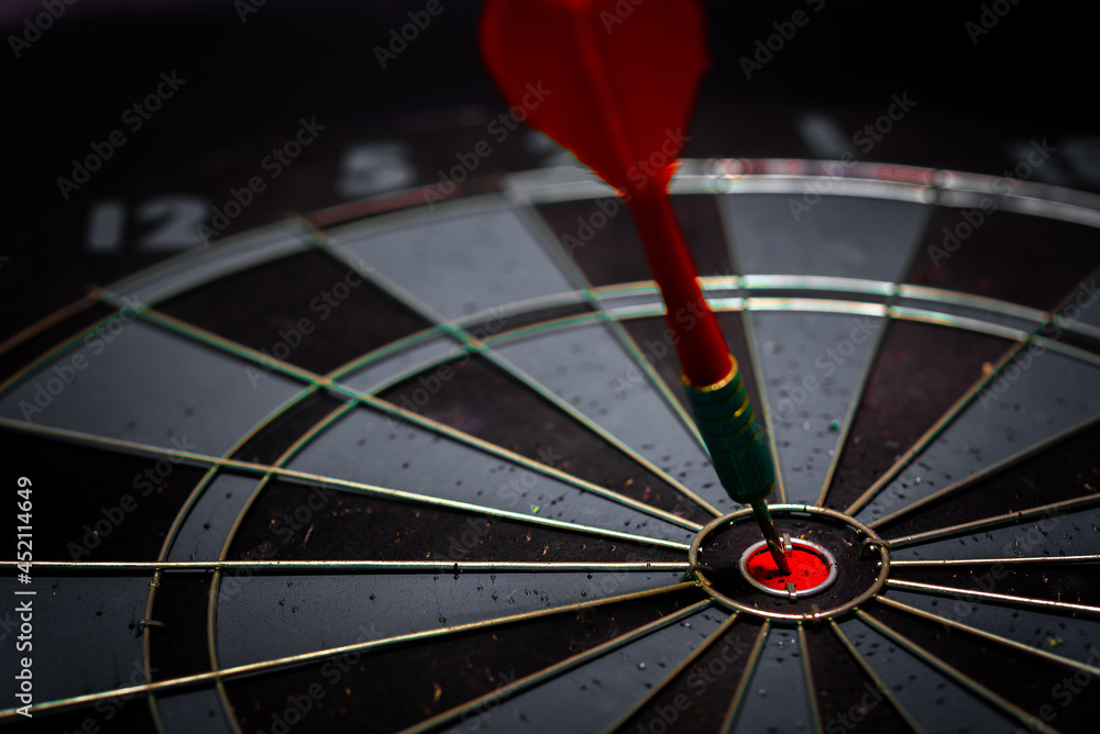 Aufkleber close up shot of the dart arrow hit on bulleyes of dartboard to represent that the business reached 