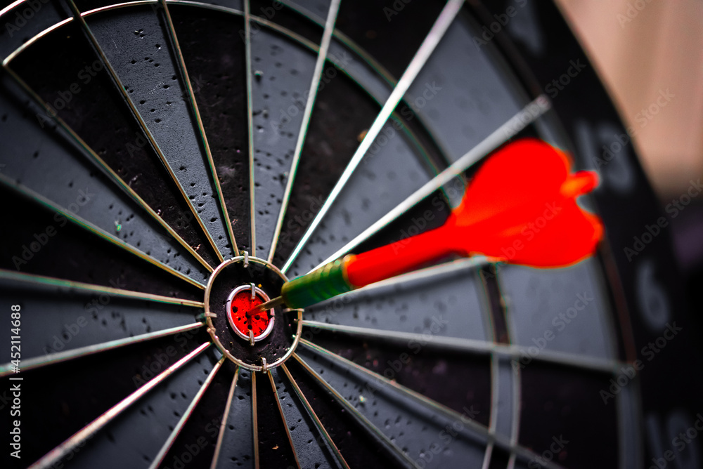 Aufkleber close up shot of the dart arrow hit on bulleyes of dartboard to represent that the business reached 