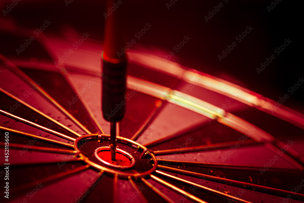 Aufkleber close up shot of the dart arrow hit on bulleyes of dartboard to represent that the business reached 