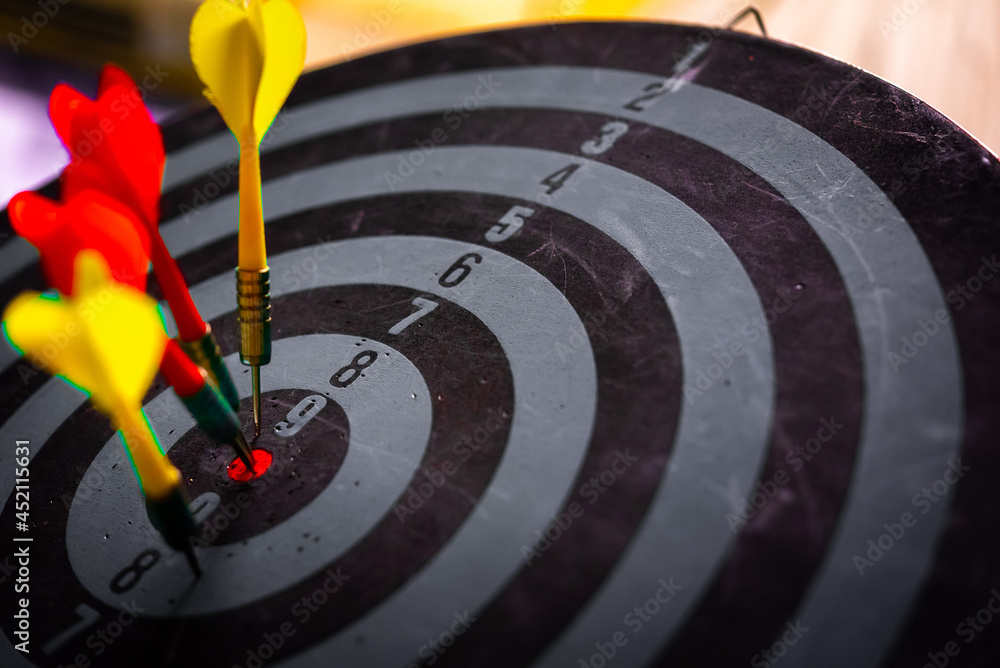 Aufkleber close up shot of the dart arrow hit on bulleyes of dartboard to represent that the business reached 