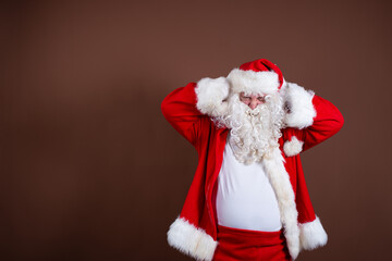 Upset Santa Claus with hands over ears