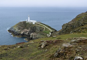 Long distance view of South Stacks lighthouse on the coast of Anglesey, North Wales. 