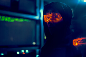 Cyber hacker breaks into databases to obtain information using a computer.