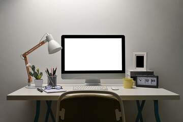 Front view with whitoffice desk that have lamp, stationary set, cactus, notepapers, eyeglasses, computer, keyboard, mouse, cup of coffee, books, table clock, picture frame decorated.