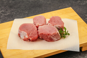 Raw pork medallion served rosemary