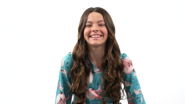 smiling happy kid girl with long curly hair laughing out loud, positive emotions