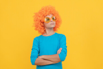 serious selfish child girl in curly wig and party glasses, selfish