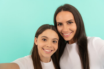 teen girl child with mom making selfie. family values and togetherness. positive smile