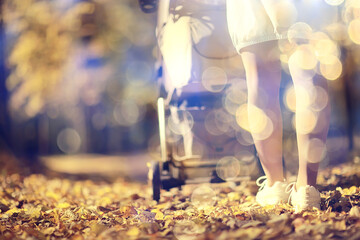 stroller view from the back legs, mom walk autumn abstract background fragment