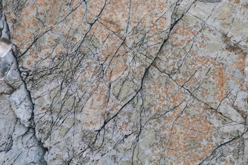 texture of a light gray stone with white and yellow-orange splashes. Texture mountain close up. Background for wallpaper on the phone, computer with the texture of a stone mountain