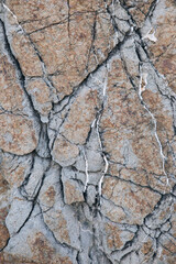 texture of a light gray stone with white and yellow-orange splashes. Texture mountain close up. Background for wallpaper on the phone, computer with the texture of a stone mountain