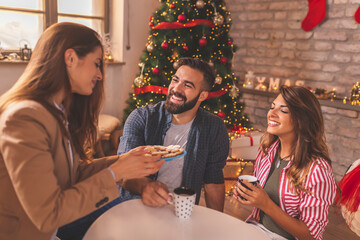 Couple spending Christmas day at home with friends