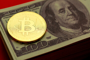 Golden coin with crypto currency sign and symbol on pile of dollar banknote. Idea for blockchain,...