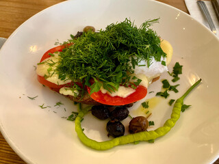 Healthy Breakfast Plate Tartine with Dill, Poached Egg and Green Pepper served at Restaurant.
