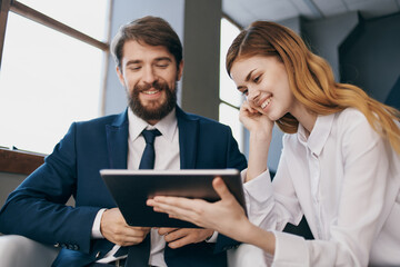 colleagues looking at the tablet technology office