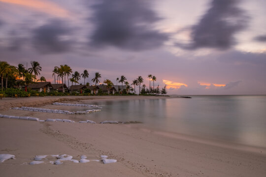 Beautiful vivid sunrise over beach with the villas in the Indian ocean, Maldives. Crossroads Maldives, hard rock hotel, july 2021. Long exposure picture