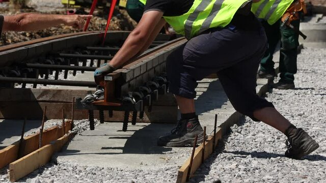 Workers install new tram rails during a reconstruction of the route.