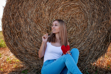 Woman sitting on hay bale
