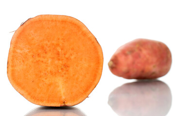 One whole and one half fresh juicy sweet potato, close-up, isolated on white.