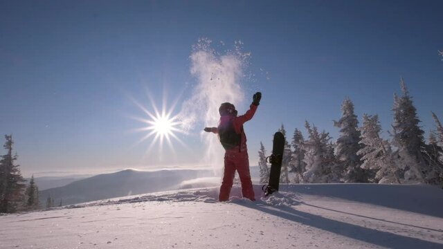 Slow motion video Woman with snowboard on a sunny winter day