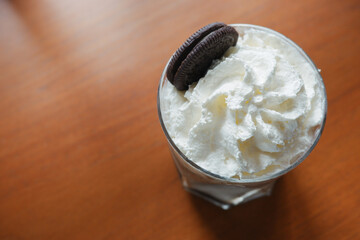 iced coffee with fresh milk and biscuits on a wooden table. Fresh drinks to relax. top view