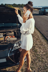 Woman calling tow truck for her damaged car