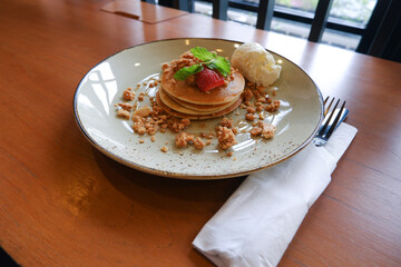 Vanilla crumb pencakes with ice cream and topping strawberry