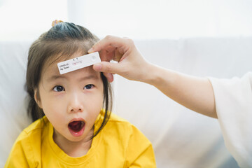 Adorable kid toddler show her result test that holding by parent hand, Rapid test kit that appear...