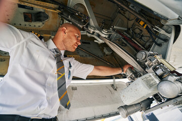 Airline captain inspecting an aircraft before the flight