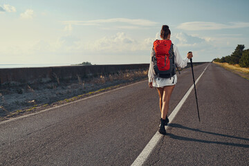 Traveller walking in the middle of automobile road