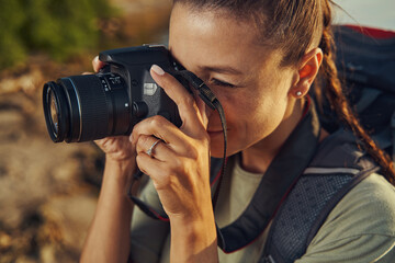 Woman focusing her camera while making photograph