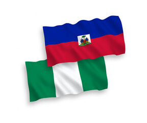 National vector fabric wave flags of Republic of Haiti and Nigeria isolated on white background. 1 to 2 proportion.