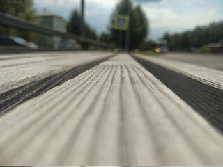 A tree in the street, the perspective going into the distance of the street.