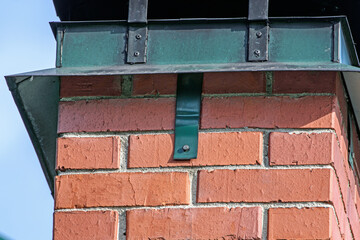 The upper part of a brick chimney is a close-up