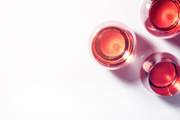 Rose wine of different shades in glasses on white background. Rosado, rosato or blush wines tasting