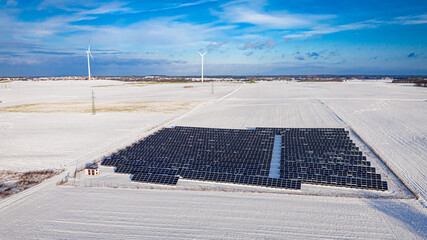 Alternative energy in Poland. Snowy photovoltaic farm in winter.