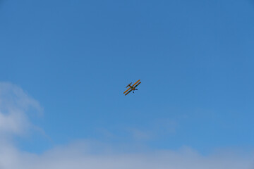 Biplane flying with blue sky in background