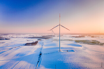 Wind turbine on winter snowy field. Alternative energy, Poland