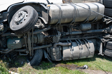 Fototapeta na wymiar The truck is lying on its side in a car accident on the highway