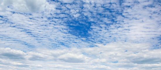 Panoramic landscape with blue sky and clouds.