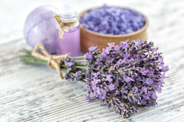 Fototapeta premium lavender's spa products with dried lavender flowers on a wooden table. Flat lay bath salt and massage oil on wooden background. Skin care, beauty treatment concept. Lavendula oleum