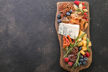 Antipasto background. Different Italian snacks with fruit, nut on a rustic background.