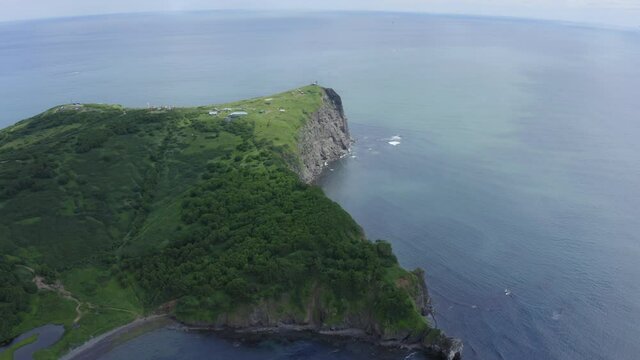 Mayachny Cape on Kamchatka Peninsula on picturesque Avacha bay coast covered by green grass in the Pacific Ocean