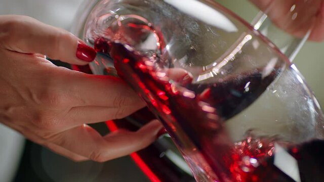 Sommelier pouring red wine from bottle into decanter . Close-up footage of wine mixing process in carafe . Preparation process to degustation of wine. Shot on RED HELIUM Cinema Camera in Slow Motion