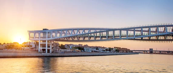 Photo sur Plexiglas Helix Bridge Modern twisted bridge over the Dubai Water Canal in United Arab Emirates at sunset.