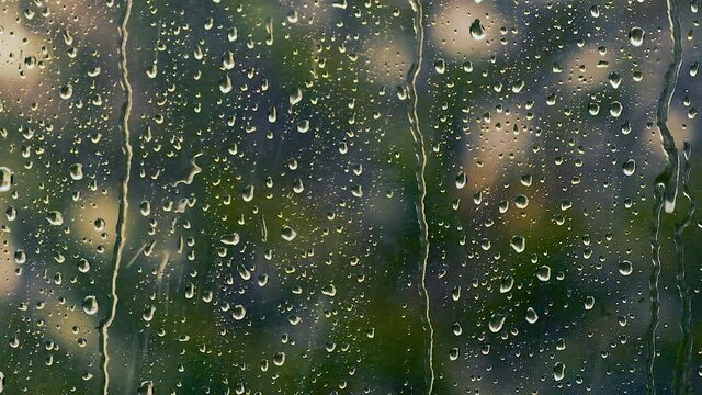 heavy rain falling on the window surface