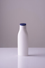 white bottle of cream on a white-gray background background. Skin care cream, anti-tan