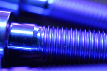 Anodized titanium alloy bolt macro photograph