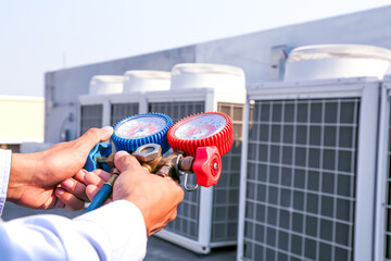 Air condition maintenance and servicing, Close up hand mechanic using measuring manifold gauge for...