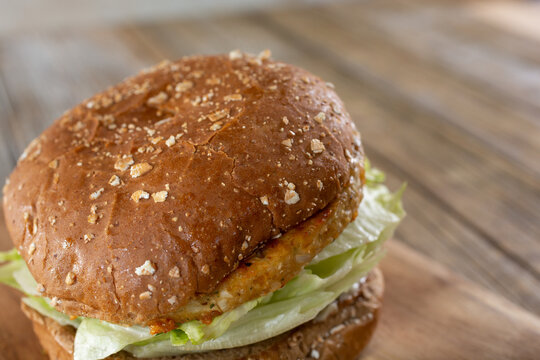 A Closeup View Of A Burger Featuring Whole Wheat Buns.